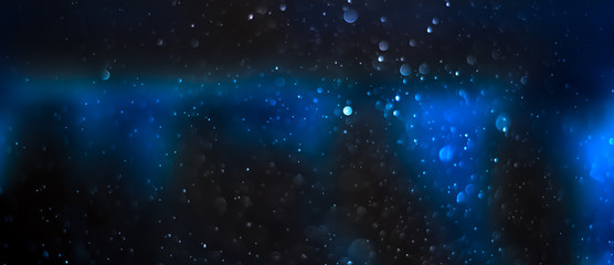 Abstract blue glitter galaxy space bokeh background