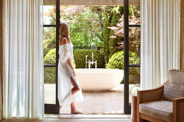 Woman standing in doorway at luxury resort