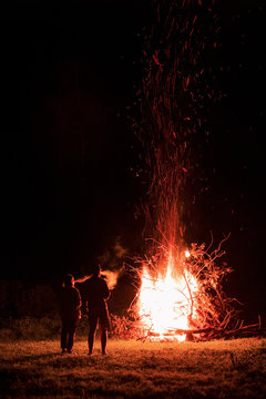 Silhouette of couple against the background of a fire flame