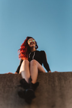 A teenage girl watching the sunset in the city