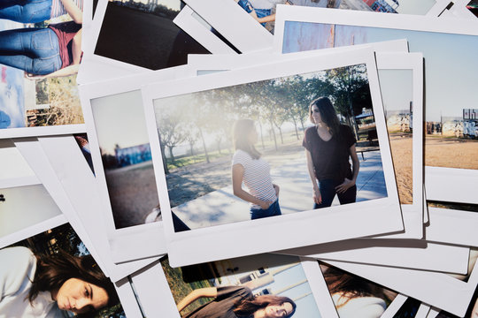 Friends in sunny park on polaroid shot.