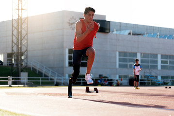 Disabled man athlete training with leg prosthesis