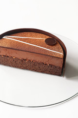 Vegan Dark Chocolate Brownie Cake with Chocolate Truffle Mousse, on white background.