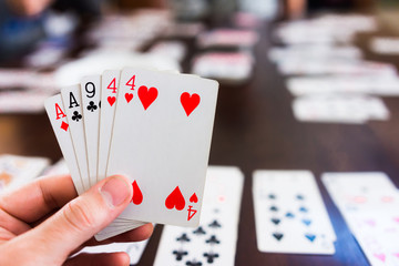 Hand of playing cards in card game