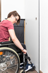 Fototapeta na wymiar disabled woman opens a door in her flat