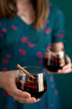 Woman at party holding mulled wine cocktails