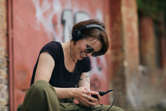 Female listening to music on headphones.