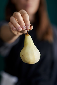 Hand holding pear prepared for baking