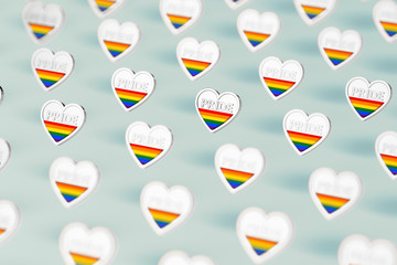 Silver heart with rainbow and word PRIDE inside. Month of pride concept. Isolated on pastel green background. 3D rendering
