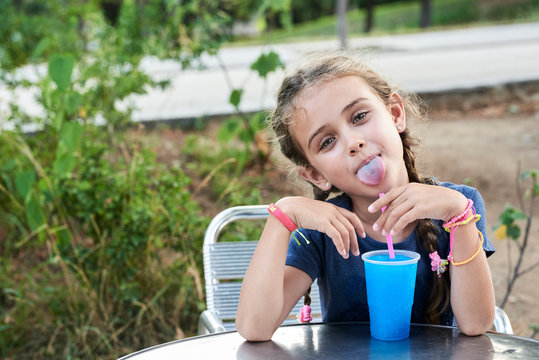 Portrait Of Little Girl With Tongue Out.