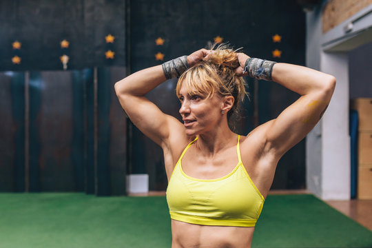 Sporty woman adjusting the ponytail
