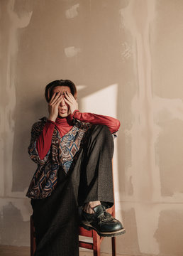Young man covering eyes with hands