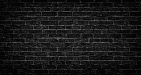 Fototapeta na wymiar Black brick wall texture. Aged stone block masonry. Dark gloomy background