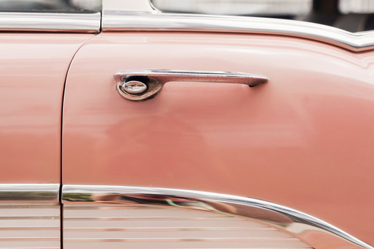 door detail on a pink vintage car