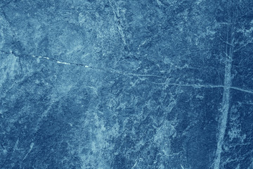 Vintage blue background. Rough painted wall of sapphire color. Imperfect plane of blue colored. Uneven old decorative toned backdrop of cyan tint. Texture of sapphirine hue. Ornamental stony surface.