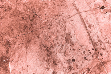 Vintage pink background. Rough painted wall of living coral color. Imperfect plane of beige colored. Uneven old decorative toned backdrop of beige tint. Texture of pink hue. Ornamental stony surface.