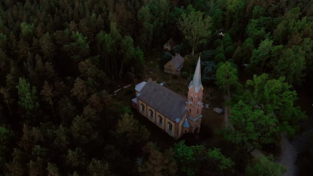 Aerial top view of beautiful church in Jurmala during Golden Hour sunset - Sala Sv. Janis ev. lutheran