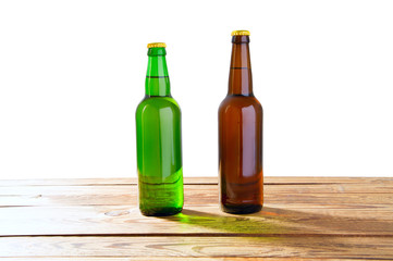 Photo of two different full beer bottles with no labels. Separate clipping path for each bottle included.2 two separate photos merged together. Glass bottles odifferent beer on light white background