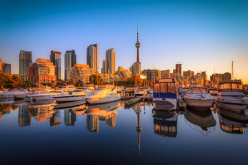 View of harbor in a yacht club at Toronto city during sunset with Canadian tower as background