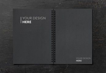 Open Notebook Mockup on a Black Table
