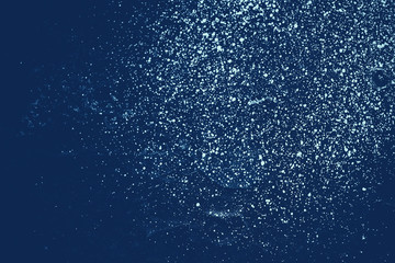 Obraz premium Vintage blue background. Rough painted wall of sapphire color. Imperfect plane of blue colored. Uneven old decorative toned backdrop of cyan tint. Texture of sapphirine hue. Ornamental stony surface.