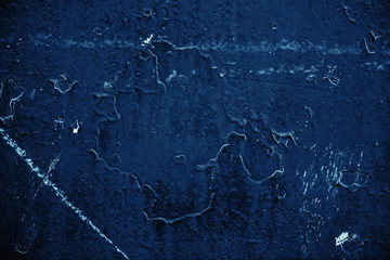 Vintage blue background. Rough painted wall of sapphire color. Imperfect plane of blue colored. Uneven old decorative toned backdrop of cyan tint. Texture of sapphirine hue. Ornamental stony surface.
