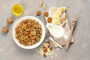 Granola with nuts and milk on a bright table.
