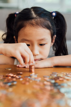 Little girl counting coins