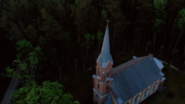 Aerial top view of beautiful church in Jurmala during Golden Hour sunset - Sala Sv. Janis ev. lutheran