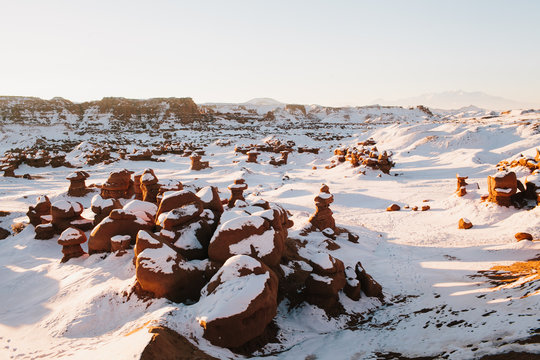 Snowy landscape in Utah in the winter with snow in the ground at Goblin Valley