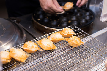 Coconut Milk on Ball mold oven to make crispy outside and soft inside, Thai Style sweet coconut layer cake for Thai Street Food which open booth in Supermarket