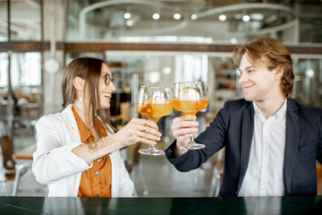Business partners having unofficial meeting, drinking together some cocktails at the bar