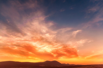 Fototapeta na wymiar stunning sunrise in the mountains in orange tones