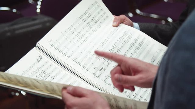 Conductor presents score / classical music / symphony