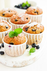 Oat muffins with blueberries on a dark background.