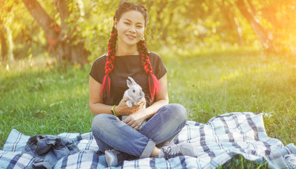 Pretty Asian Girl Hugging Bunny on Summer Nature