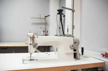 Industrial sewing machine in tailor's workshop