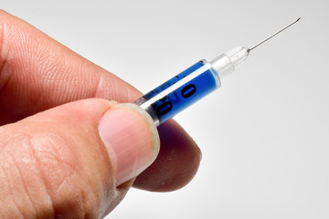 Medical syringe held with fingers