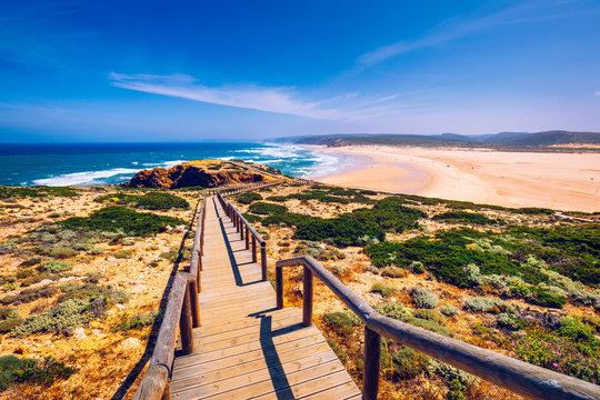 Praia da Bordeira and boardwalks forming part of the trail of tides or Pontal da Carrapateira walk in Portugal. Amazing view of the Praia da Bordeira in portuguese. Bordeira, Algarve, Portugal.