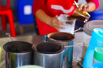 Woman's hands preparing traditional iced coffee cup - traditional coffee drink - fresh coffee drink preparation