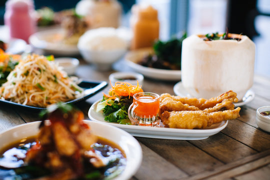 Assorted Thai food on wooden table