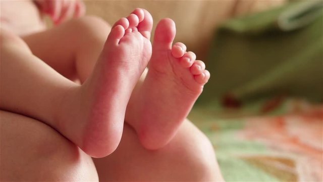 cute baby feet moving toe close up