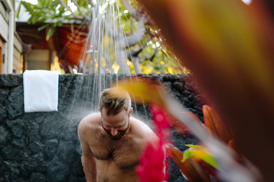Man Showering Outside In Tropics