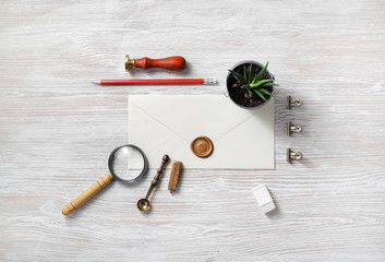 Vintage stationery and blank envelope on light wood table background. Template for graphic...