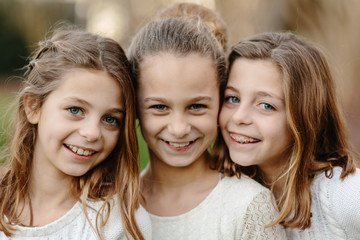 Close up of three sister standing together