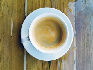 white cup of hot coffee on table