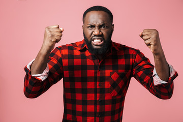 Portrait of an angry african man wearing plaid shirt