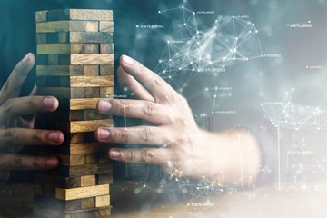 business man try to start built wood block to success with virtual icon and connecting line contact...