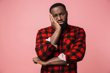 Portrait of a pensive african man wearing plaid shirt