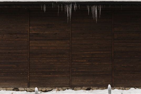 Dark wooden winter background with icicle